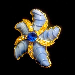 Costume jewelry, blue stone in the middle, gold tone, with stones brooch